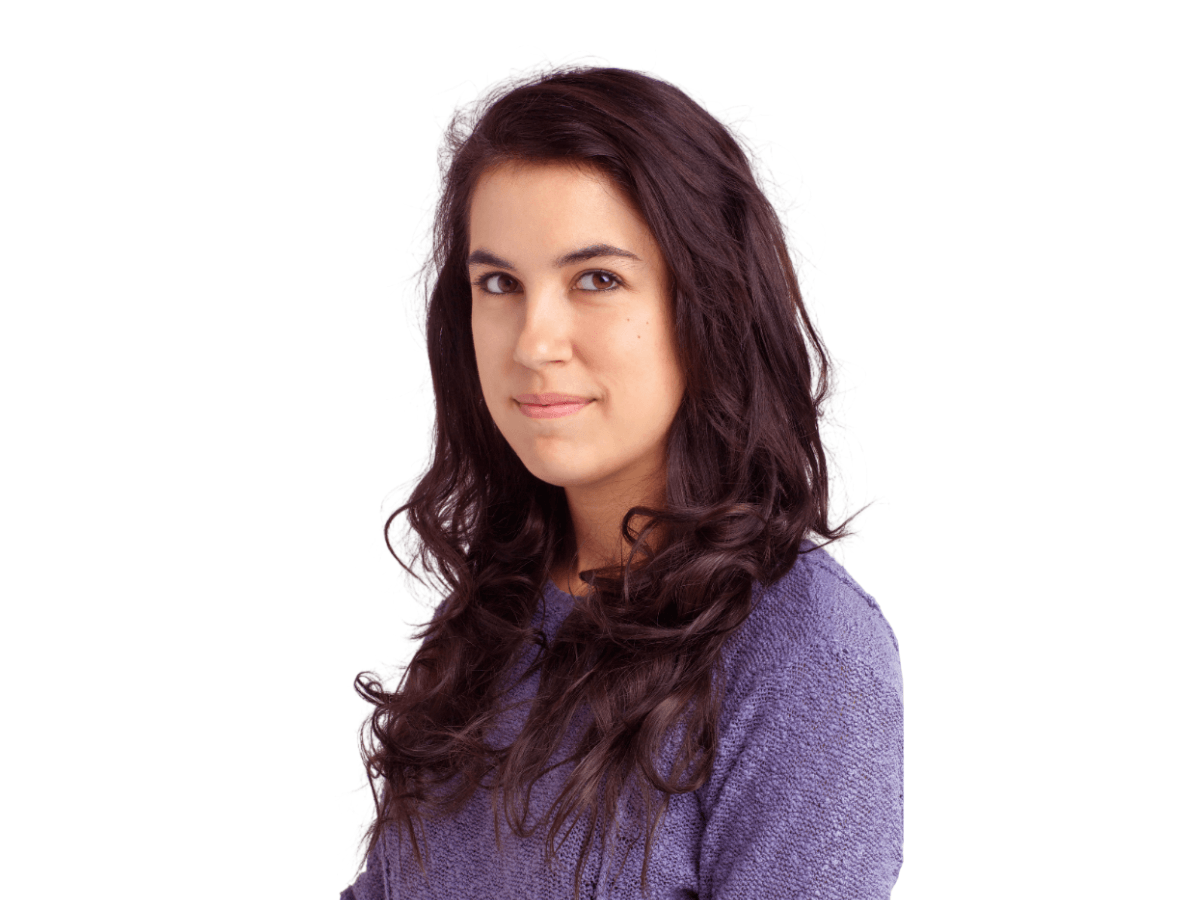 Smiling woman with long dark hair, purple sweater