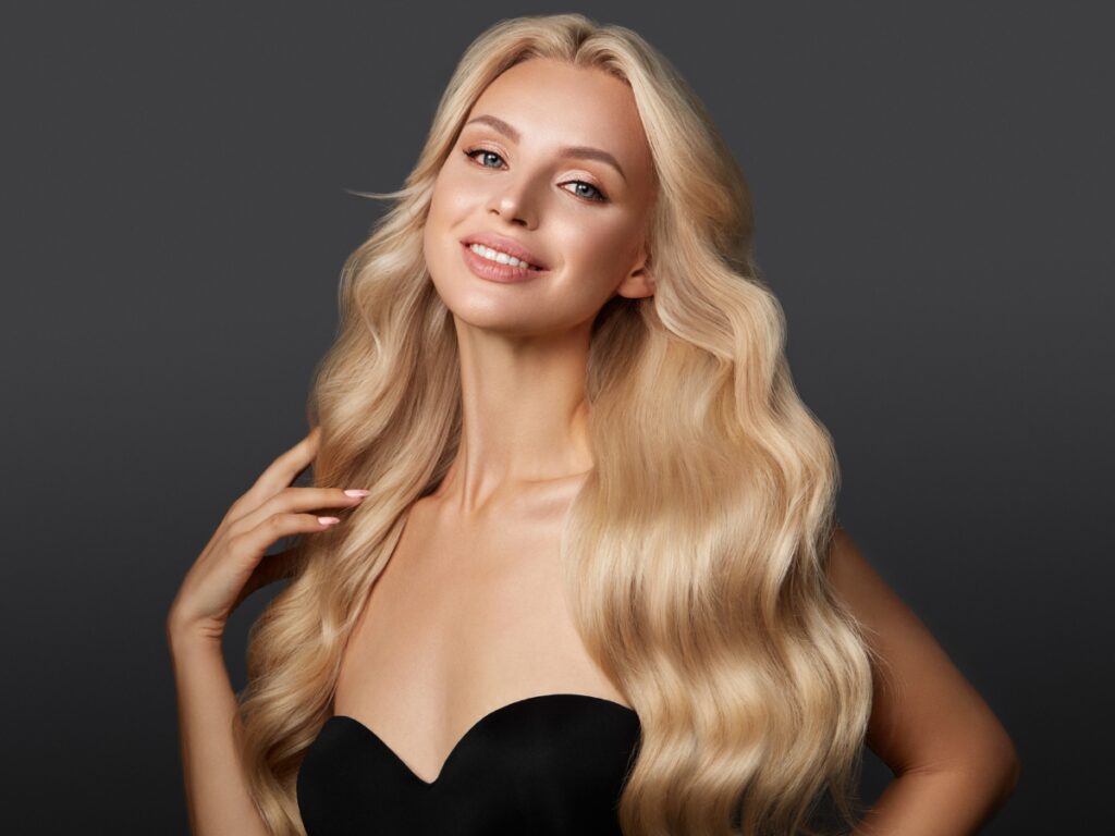 Smiling blonde with voluminous salon waves