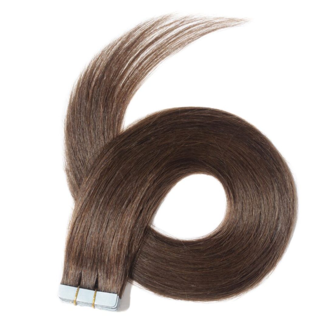 Brown tape-in hair extensions coiled on white