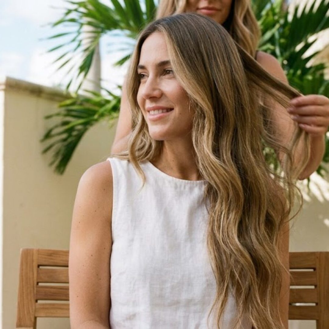 Stylist adjusting long beachy waves outdoors