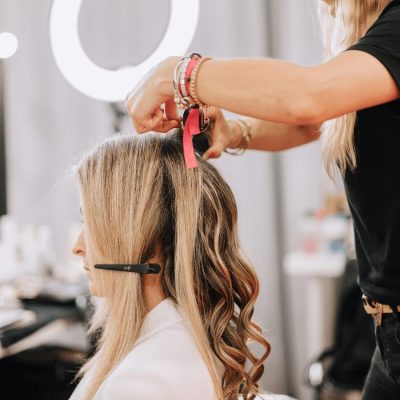 Hairdresser attaching extensions to client’s hair Tape in Hair Extensions - 1